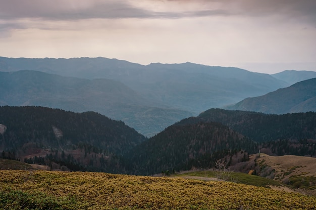 Autumn in the North Caucasus, Rosa Khutor ski resort in off-season. Russia, Sochi. Vintage toning. Travel background. Dramatic sky, sunset time, beautiful heavy clouds.