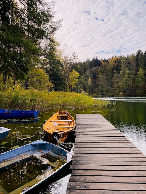 Autumn pier Boats on the autumn lake