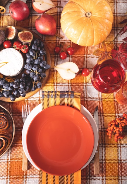 Autumn place setting dinner for celebration Thanksgiving Day Holiday party Festive table Snacks friutspie pumpkin vegetables wine glasses