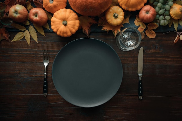 Autumn place setting with leaves and pumpkins