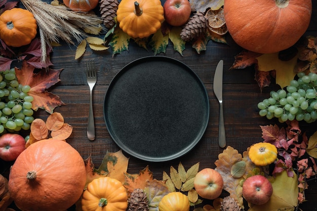 Autumn place setting with leaves and pumpkins