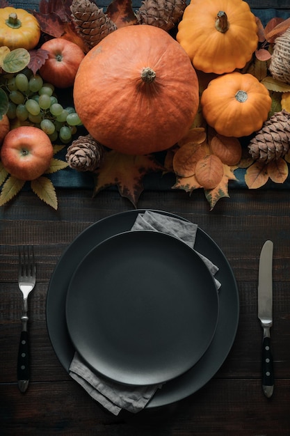 Autumn place setting with leaves and pumpkins