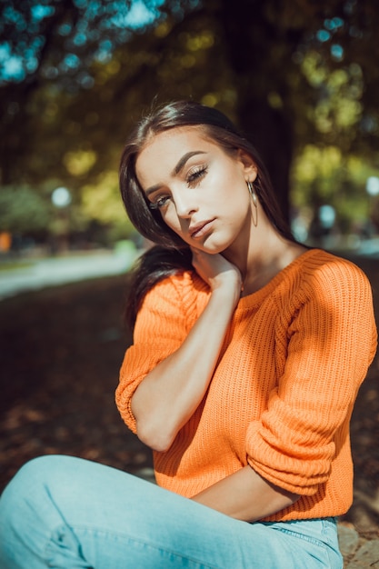 Autumn portrait of fashionable young woman looking at camera