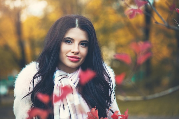 Autumn portrait of young woman in fall park outdoors