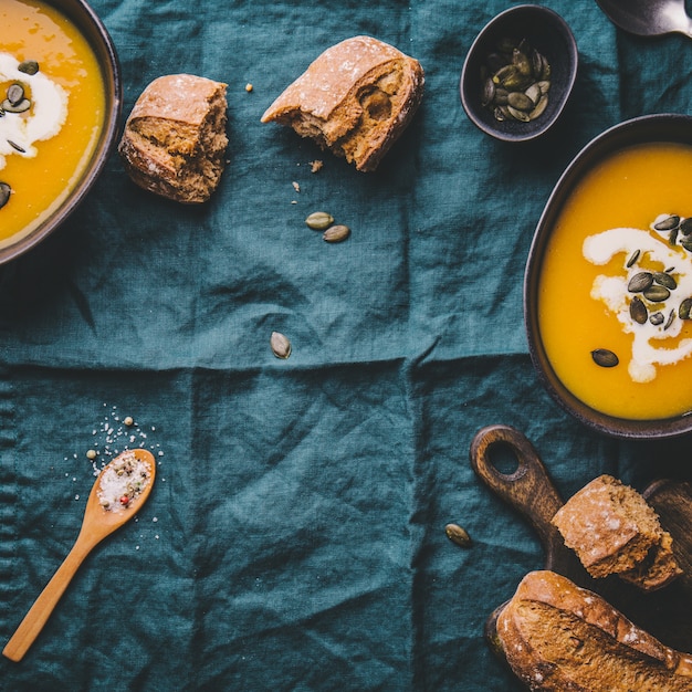 Autumn pumpkin creamy soup in bowls