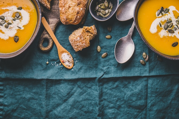 Autumn pumpkin creamy soup in bowls