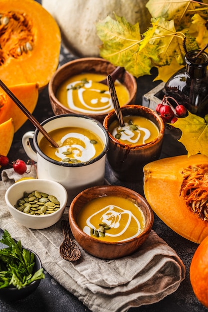 Autumn pumpkin soup puree with cream in cups, the autumn scenery