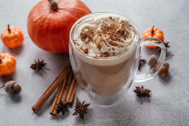 Autumn pumpkin spiced latte with whipped cream and cinnamon