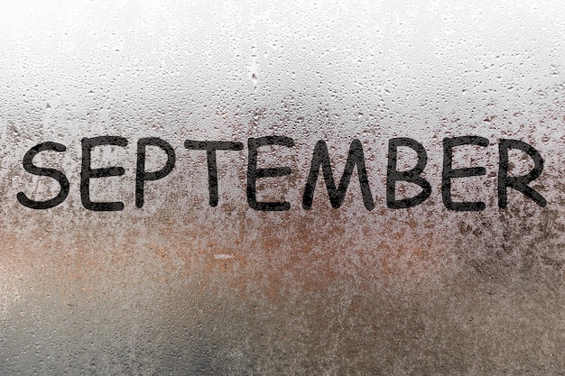 Autumn rain, the inscription on the sweaty glass - September