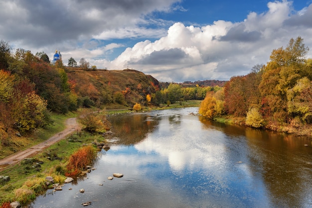 Autumn river with beautiful banks, covered with trees with leaves