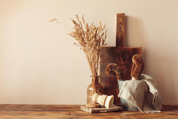 Autumn scene layout. a cup of coffee, wooden cutting boards and dried flowers in the sunlight.