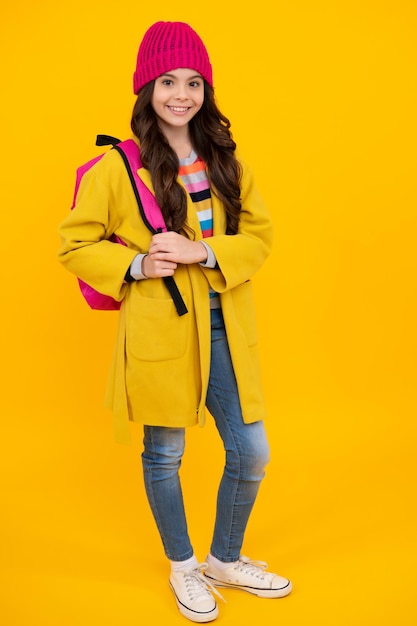 Autumn school Teenager schoolgirl in school uniform with bagpack School children on isolated studio background 1 september knowledge day