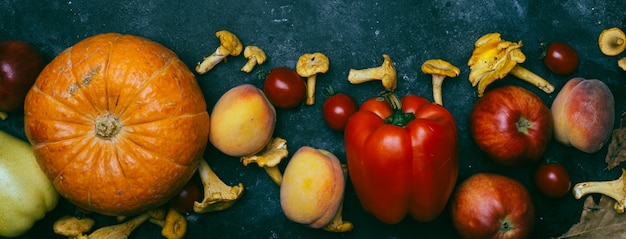 Autumn seasonal vegetables and fruit: pumpkin, pear, apples, corn, chanterelles, pepper