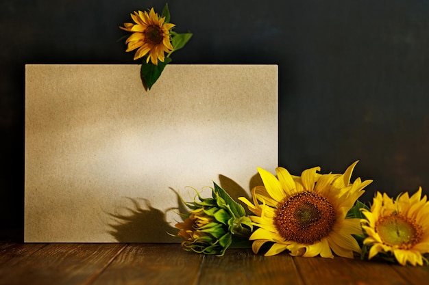 Autumn still life sunflowers and copy space on wooden table on dark background