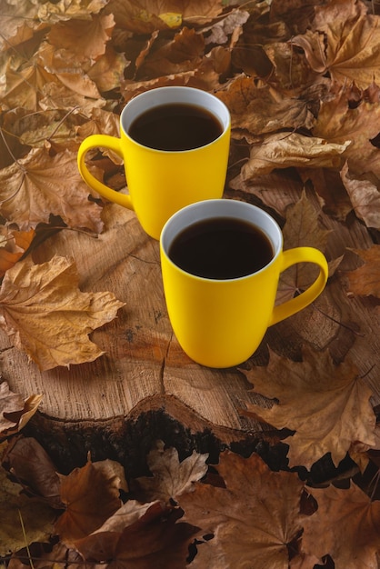 Autumn still life with a cup of coffee and fallen leaves