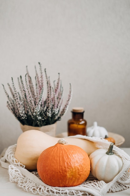 Autumn still life with pumpkins in and golden leaves on a wooden surface autumn pumpkin thanksgiving