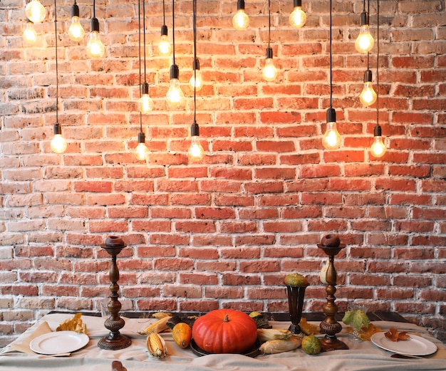 Autumn table setting for Thanksgiving day with pumpkins and candles