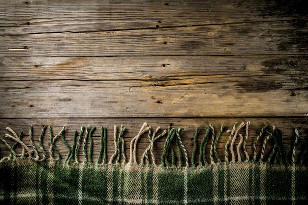 Autumn theme wooden background with plaid