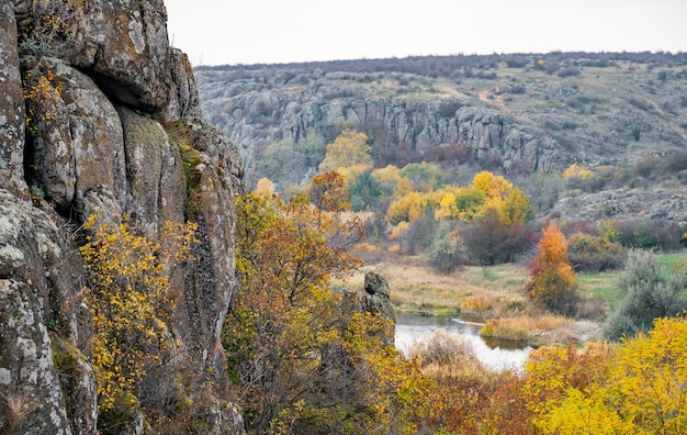 Autumn trees and large stone boulders around