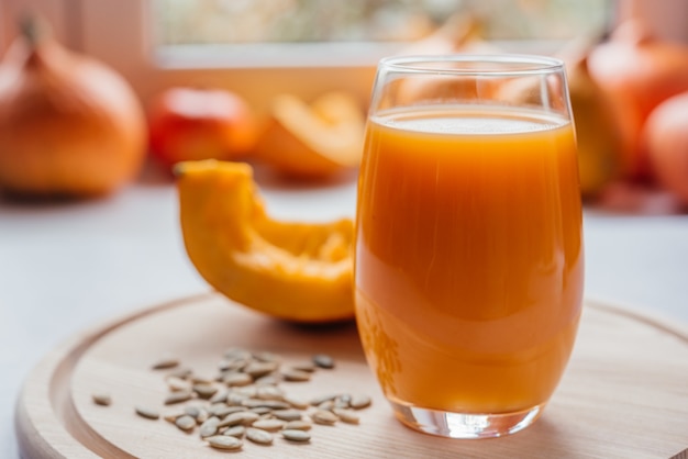 Autumn vegetable juice made of raw pumpkin, autumn seasonal juices high on vitamins and antioxidants