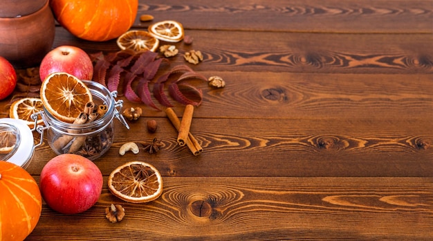 Autumn wooden background with apples spices and pumpkins Mockup for seasonal offers and holiday card top view