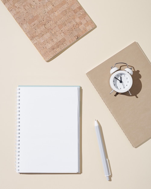 Autumn working  space with open notebook with blank pages and white clock show day time