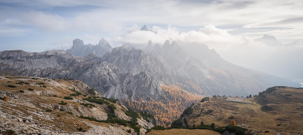 Autumnal alpine panorama with sharp mountains and fall colours dolomites italy