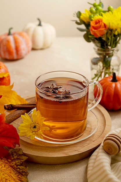 Autumnal still life flowers pumpkins and cup of tea Well being relax cozy abstract background