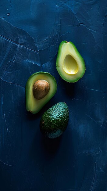 Photo avocado on a black surface with a blue background