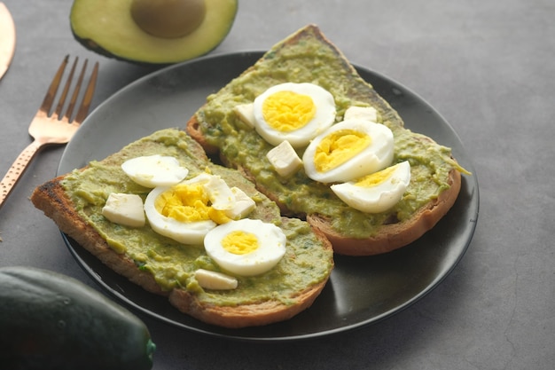 Avocado brown bread boiled egg on table