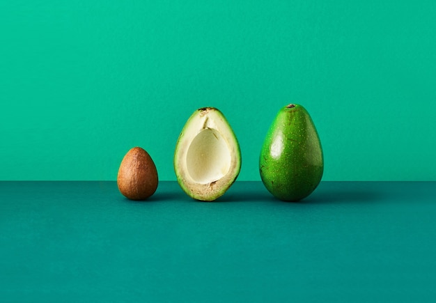 Avocado cut in half, bone from avocado isolated colored background