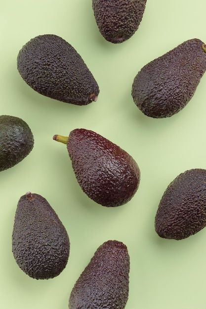 Avocado fruits on a green background