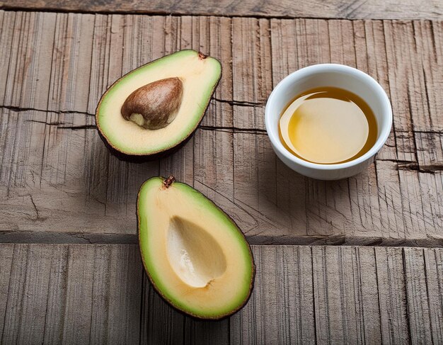 Avocado Halves Next to Bowl of Oil