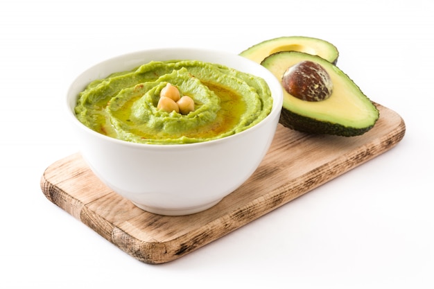 Avocado hummus with fresh avocado in bowl isolated