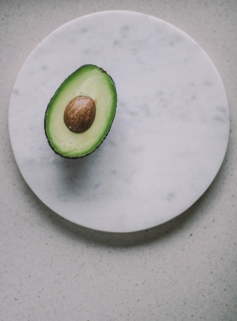 Avocado on marble table organic vegetables and healthy eating styled concept