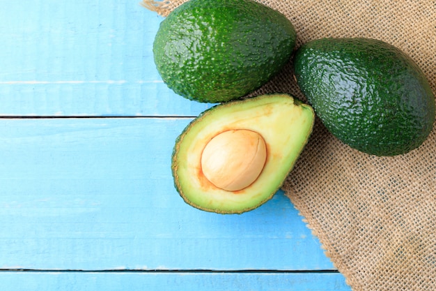 Avocado on old wooden table.