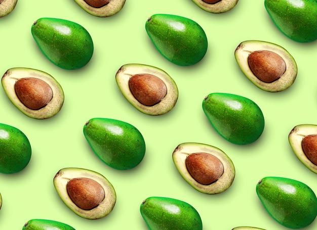 Avocado pattern cut in half with bone isolated on colored background