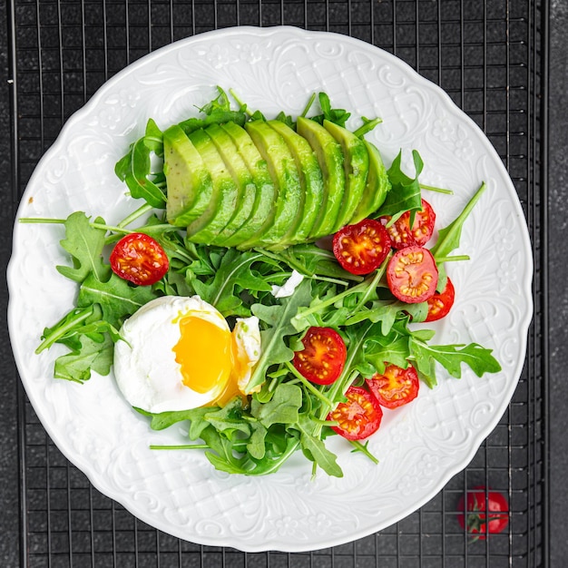 avocado salad poached egg arugula tomato green salad leaves healthy meal food snack on the table