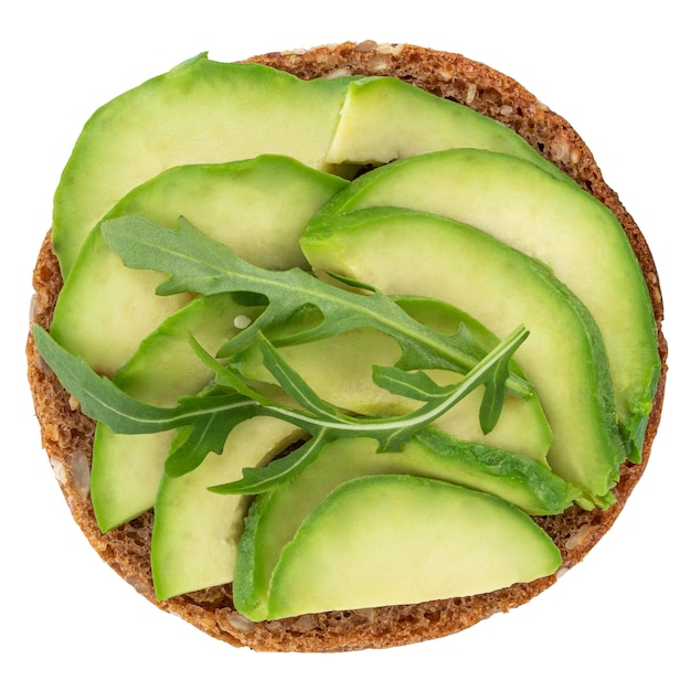 Avocado sandwich on dark rye bread with spinach isolated on white background, top view.