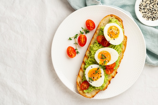 Avocado toast with toasted bread soft-boiled eggs with tomatoes