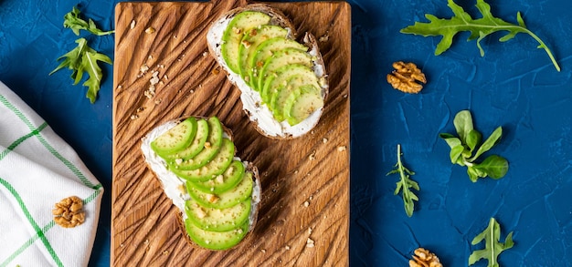 Avocado toasts for breakfast or lunch with rye bread pumpkin seeds Vegetarian food top view with copy space