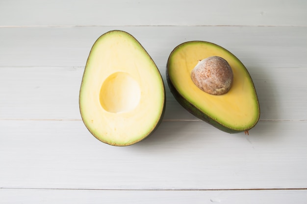 Avocado on vintage white table, Healthy food concept