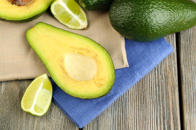 Avocado with limes on table close up