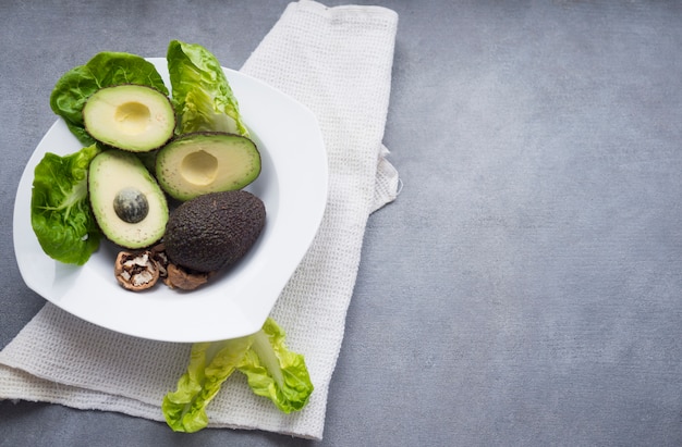 Avocados with lettuce on big plate