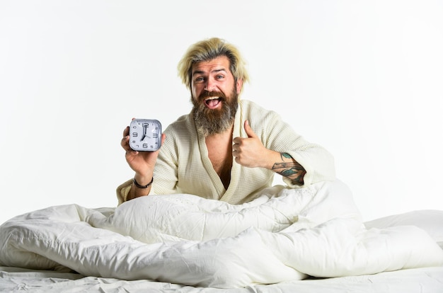 Awakening Sleep complex biological process that helps process new information stay healthy and feel rested Stressed man alarm clock Sleepy guy and alarm clock in bed Bearded man with alarm clock