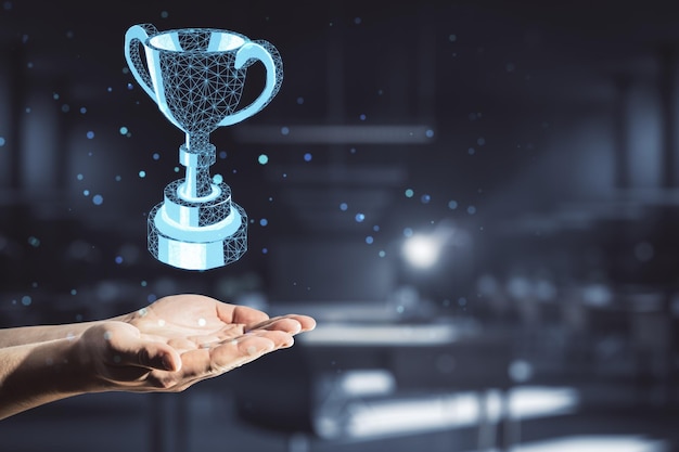 Award concept with polygonal winner trophy cup above man hand at abstract dark background