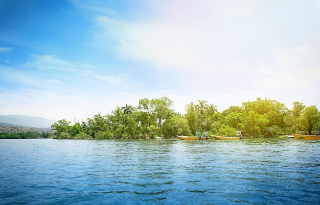 Awesome view of Grijalva river landscapes and boats at Sumidero canyon of Chiapas State in Mexico near mexican Tuxtla city, clear blue sky . High quality photo