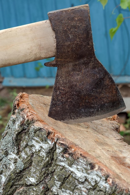 Axe and deck for cutting firewood close-up.