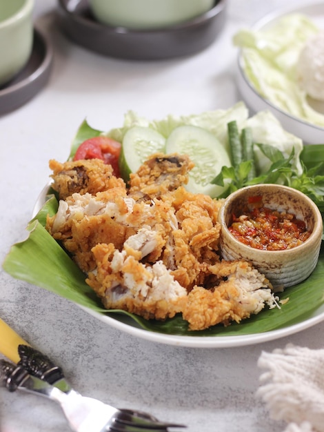 Ayam Geprek Indonesian Food crispy fried chicken with hot and spicy sambal Chili Sauce.