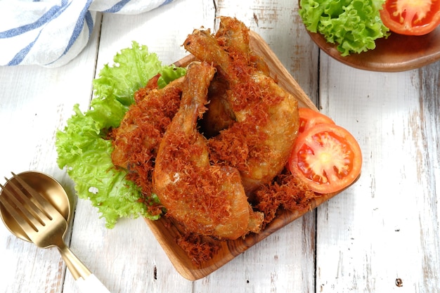 Ayam Goreng serundeng, fried chicken sprinkled with grated coconut with curry spices or serundeng